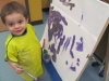 Kayden painting at the easel